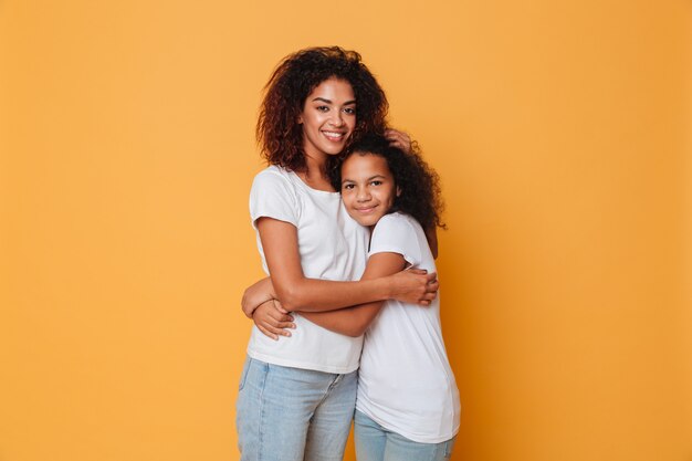 Portrait of two happy african sisters hugging