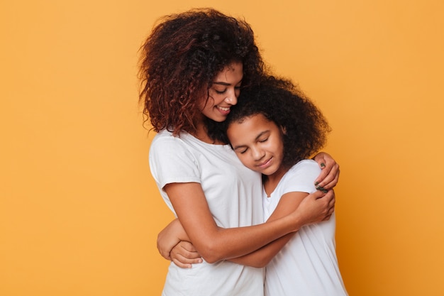 Portrait of two lovely african sisters hugging