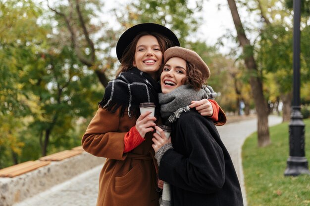 Portrait of two lovely girls dressed in autumn clothes