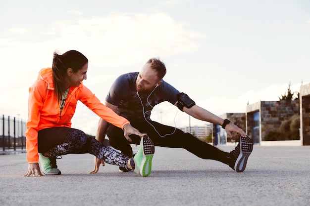 Portrait of two people stretching outdoors