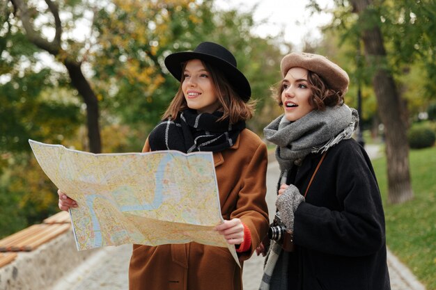 Portrait of two pretty girls dressed in autumn clothes