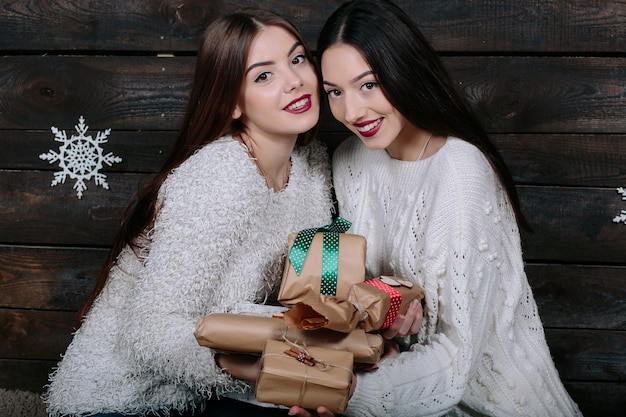 Portrait of two pretty young women with christmas gifts