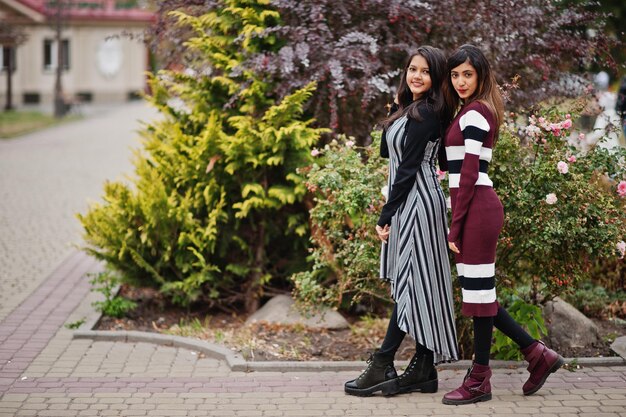 Portrait of two young beautiful indian or south asian teenage girls in dress