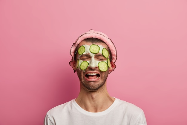 Portrait of unhappy desperate man tires of beauty treatments