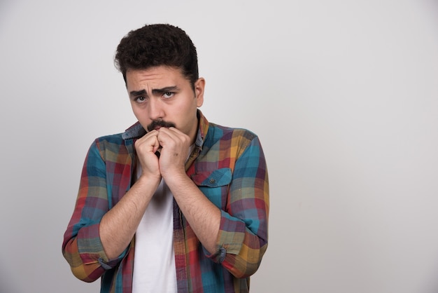 Portrait of unhappy and scared young man.