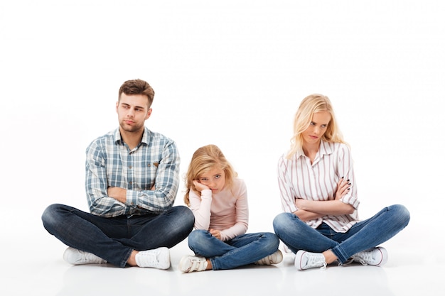 Portrait of an upset family sitting together