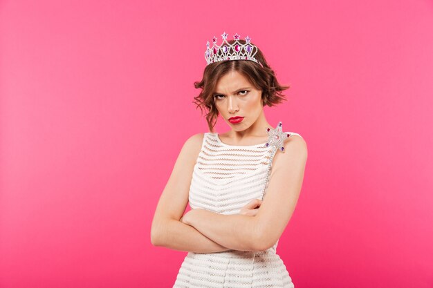 Portrait of an upset girl wearing crown