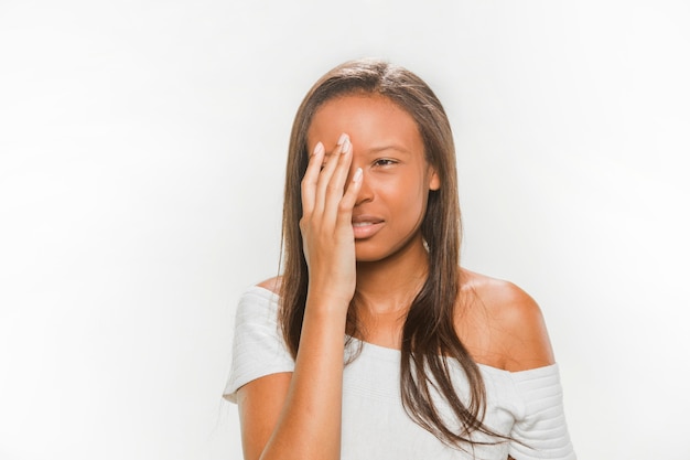 Portrait of a upset teenage girl on white backdrop