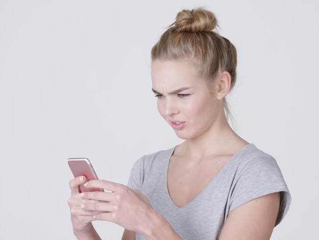 Portrait of  upset woman with mobile phone  - at studio