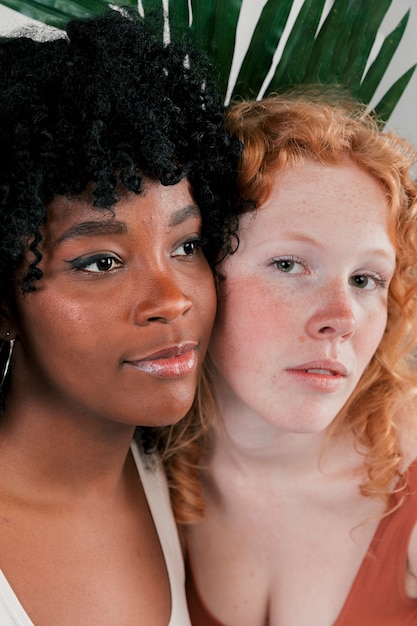 Free photo portrait of white and dark skinned women face