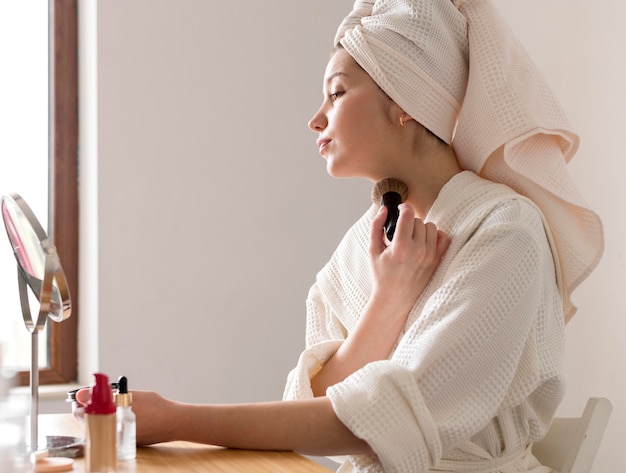 Portrait woman applying blush