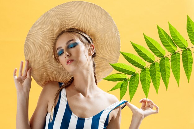 Portrait of a woman on a beach wearing a hat