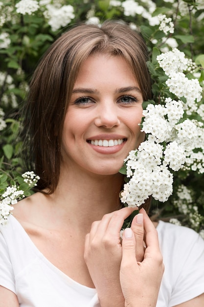 Portrait woman beside nature flowers