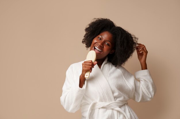 portrait of woman brushing her hair as part of her beauty regimen