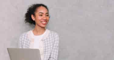 Free photo portrait woman business using laptop for work beauty black african american isolated on gray background