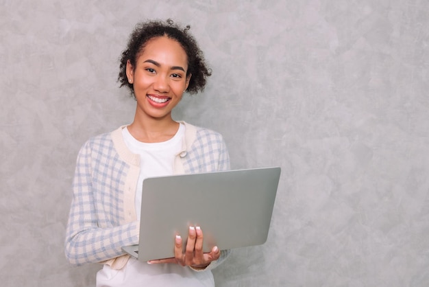 Free photo portrait woman business using laptop for work beauty black african american isolated on gray background