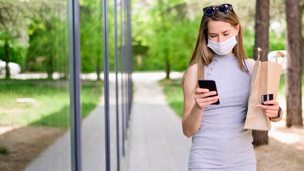 Portrait of woman carrying shopping bag outdoors