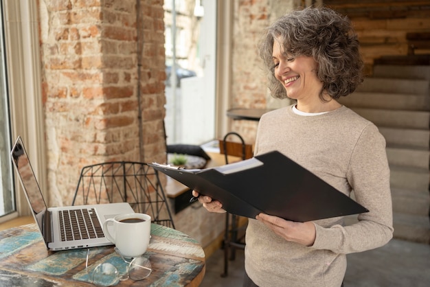 Portrait woman checking clipboard