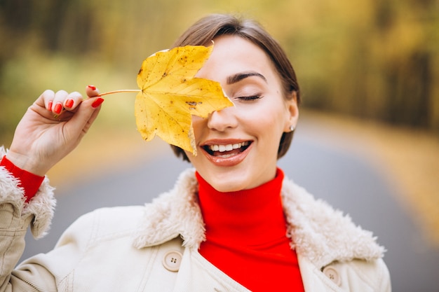 Portrait of woman covering half face with a leaf