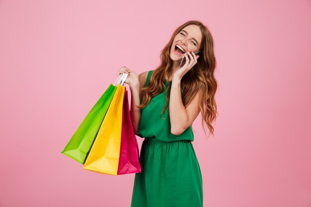 Portrait of a woman in dress talking on mobile phone