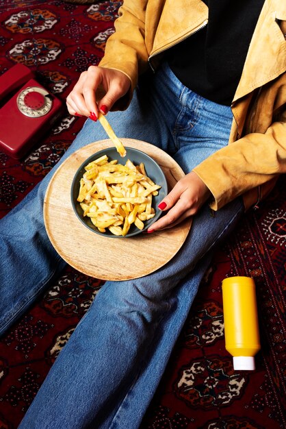 Portrait of woman enjoying a dish of poutine