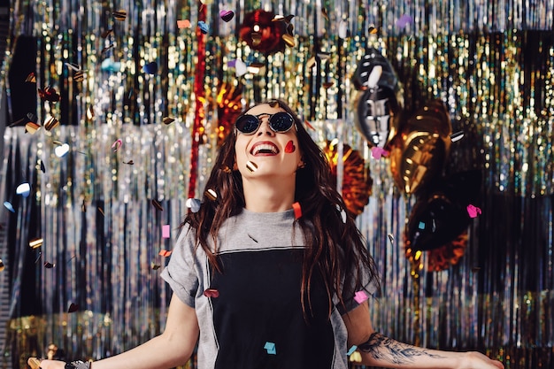 Portrait woman enjoying party and confetti