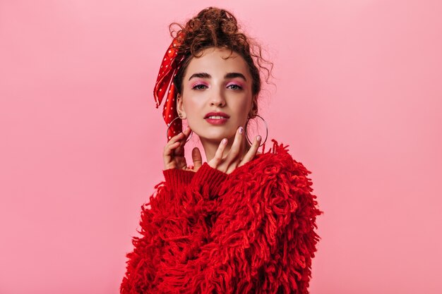 Portrait of woman in fluffy red coat looking into camera