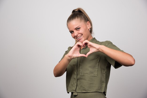 Portrait of woman giving heart to someone.