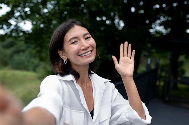 Free photo portrait of woman having a video call with her family