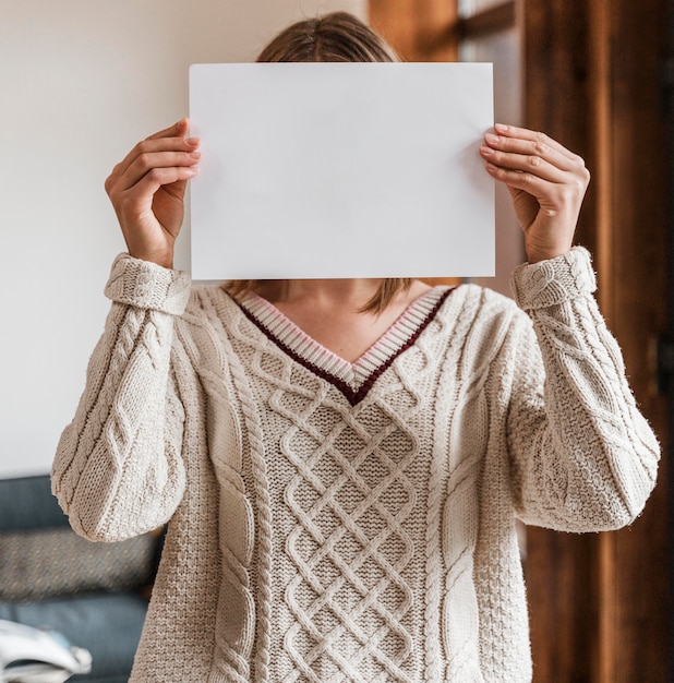Portrait of a woman holding a blank paper