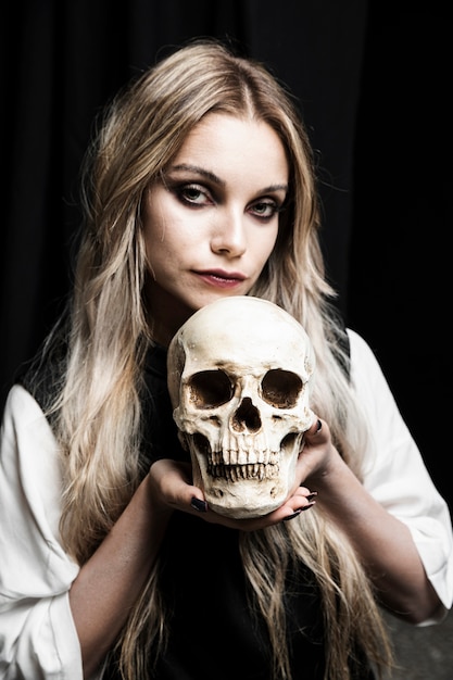 Portrait of woman holding cranium