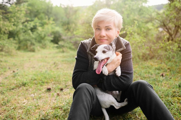 Portrait of woman holding cute dog