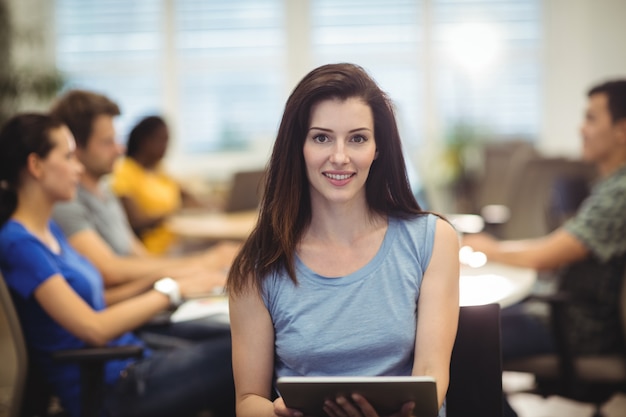 Portrait of woman holding digital tablet