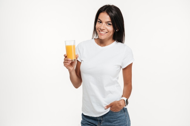 Portrait of a woman holding glass of an orange juice