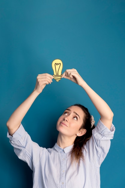 Portrait of woman holding idea light