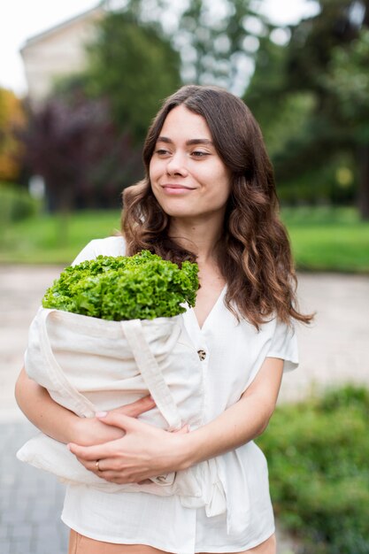 Portrait of woman holding organic shopping
