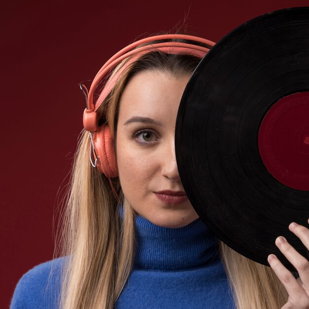 Portrait of a woman holding a vinyl disc