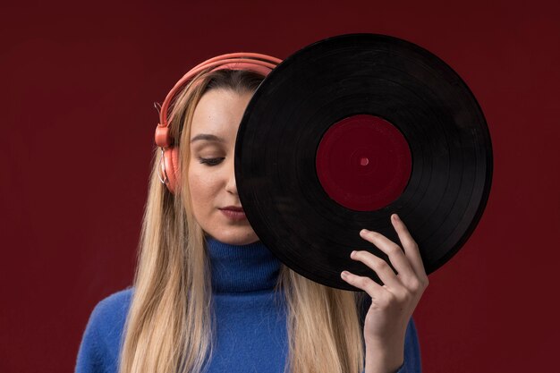 Portrait of a woman holding a vinyl disc