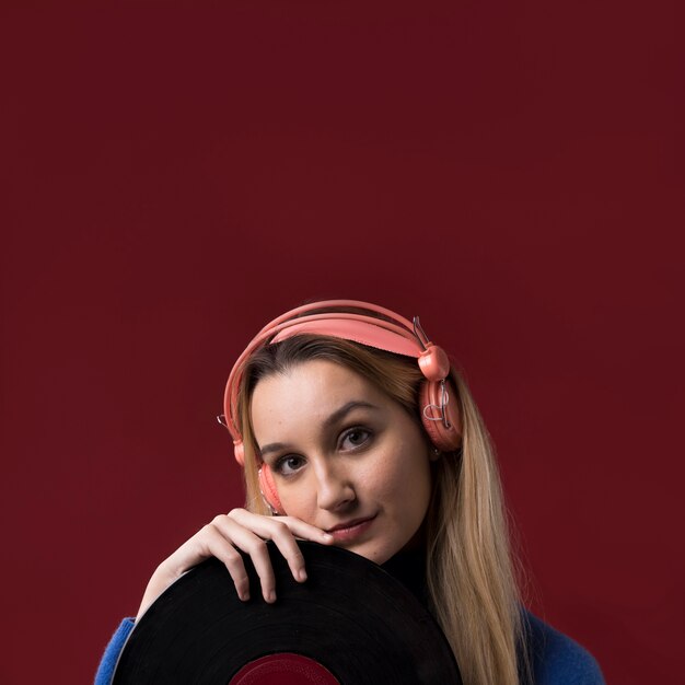 Portrait of a woman holding a vinyl disc