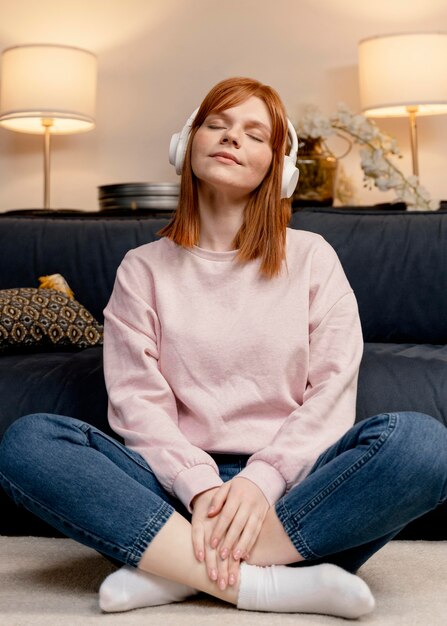 portrait woman at home listening music