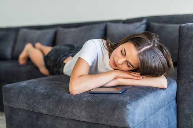 Portrait of woman lying on sofa and slipping.