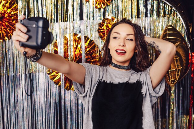 Portrait woman  making selfie on instant camera