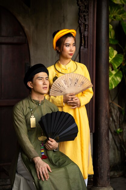 Portrait of woman and man dressed in vietnamese national costume