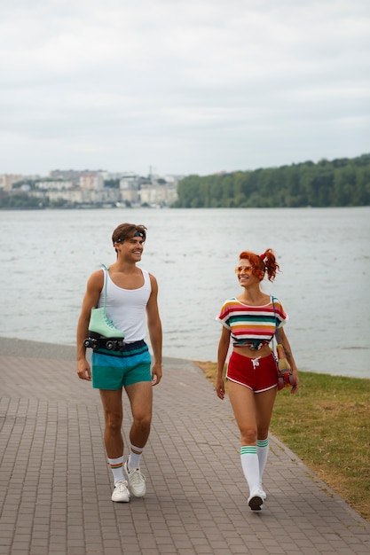 Free photo portrait of woman and man during summertime with 80's aesthetic