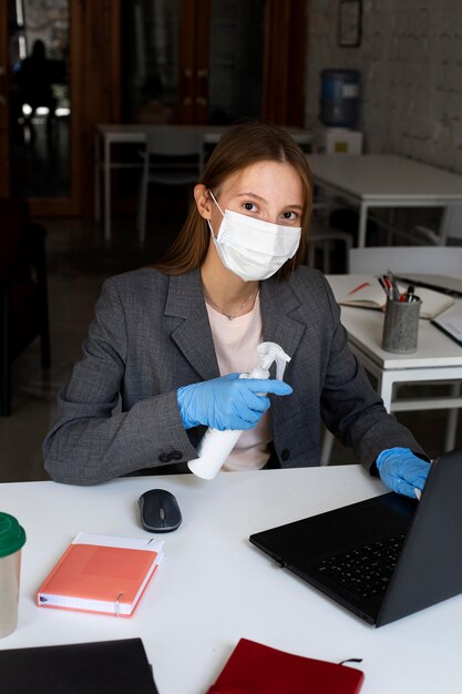 Portrait of woman at the office with face mask
