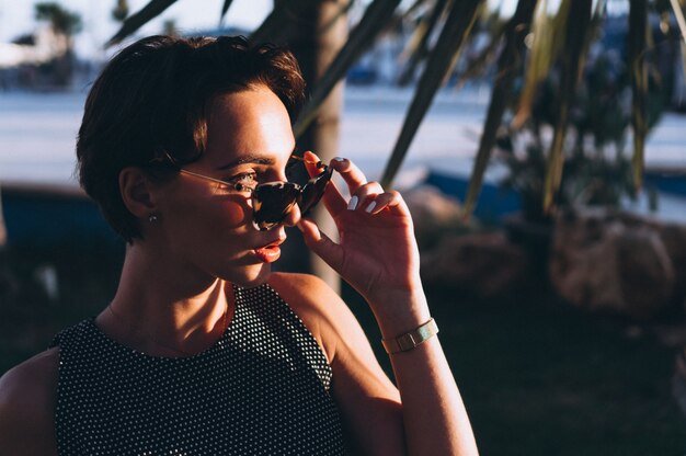 Portrait of a woman behind palm leaves