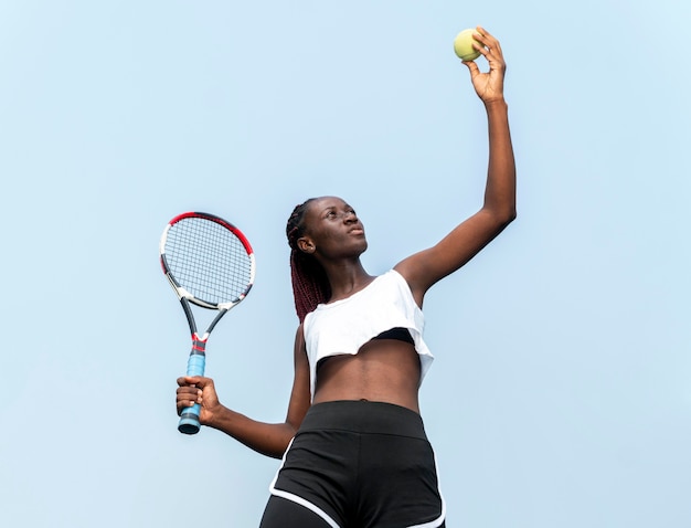 Free photo portrait woman playing tennis