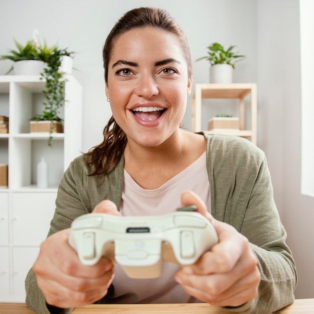 Portrait woman playing with joystick