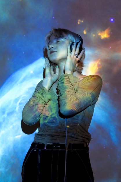 Portrait of woman posing with universe projection texture