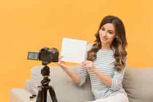 Free photo portrait of woman recording video